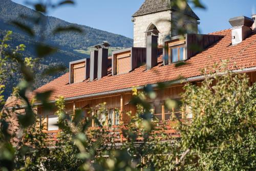 a building with a roof with a tower at Kircherhof in Bressanone