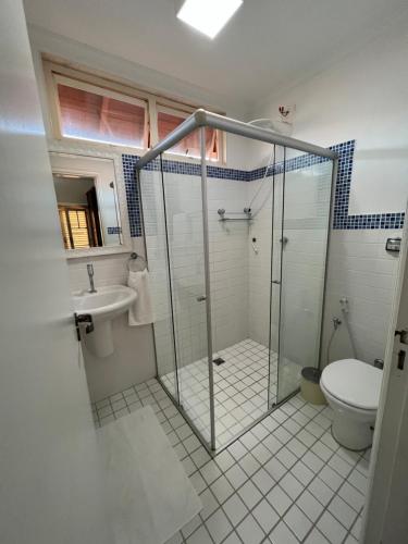 a bathroom with a shower and a toilet and a sink at Loft em Brotas in Brotas