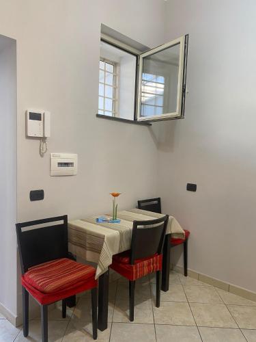 a dining room table with two chairs and a mirror at Moonlight in Castellammare di Stabia