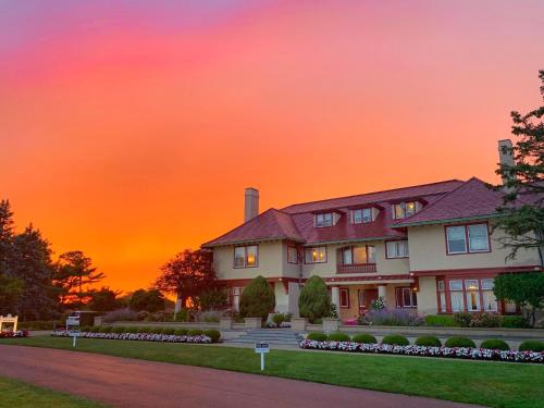 a house with a sunset in the background at The Villages at Ocean Edge Resort & Golf Club in Brewster