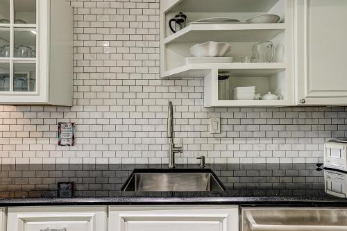 a kitchen with white cabinets and a sink at Yacht Club Villas 7542 in Hilton Head Island