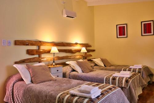 a hotel room with two beds in a room at Portal de La Cumbre in La Cumbre