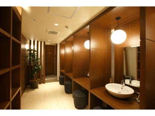 a bathroom with a sink and a mirror at HOTEL RELIEF Namba Daikokuchou - Vacation STAY 33958v in Osaka