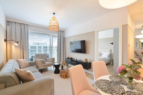 a living room with a couch and a table at Klif Apartamenty Polanki Aqua in Kołobrzeg