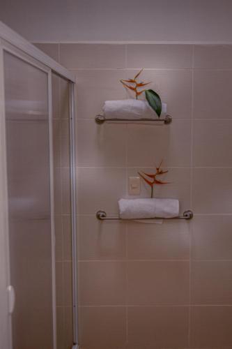 a bathroom with two towels and a shower at Azcapri Villa Boutique & Spa in Cancún