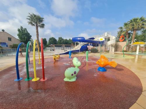 a playground with a water park with a playground at Les sables du Midi 4 in Sérignan
