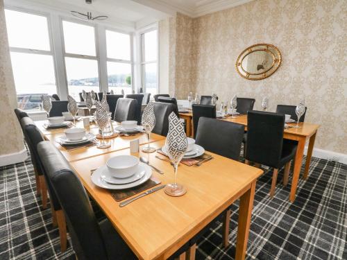 a conference room with wooden tables and chairs at Argyle House in Rothesay