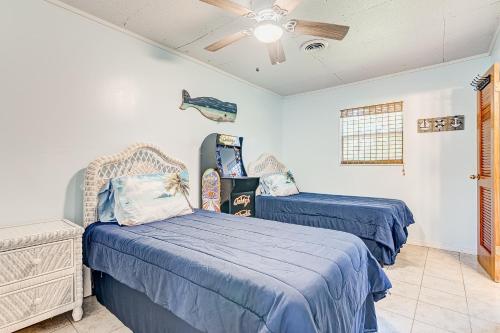 a bedroom with two beds and a ceiling fan at Sunshine Escape in Vero Beach