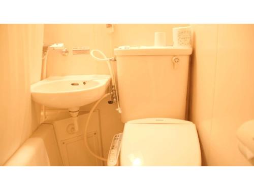 a small bathroom with a toilet and a sink at Business Hotel Chateau Est Takamatsu - Vacation STAY 11247v in Takamatsu