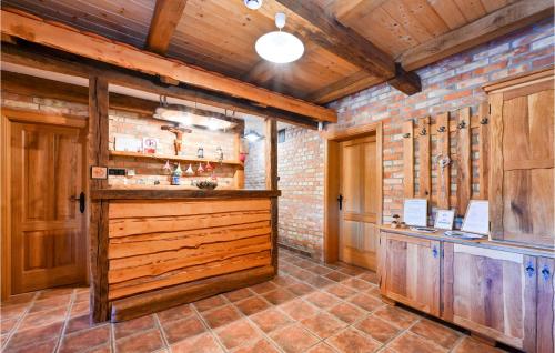 une cuisine avec des placards en bois et un bar dans une pièce dans l'établissement Cozy Home In Gornji Trpuci With Jacuzzi, à Gornji Trpuci