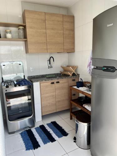 a kitchen with a stove and a refrigerator at Casa Marambaia 3 in Rio de Janeiro