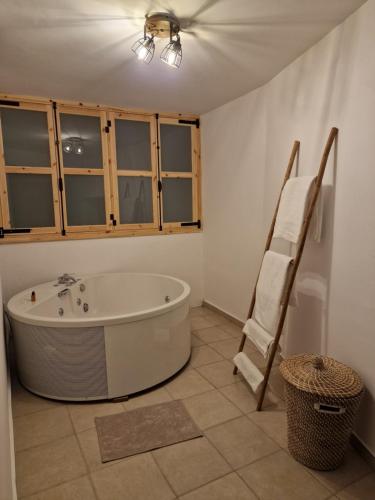 a bathroom with a bath tub in a room at Aprosmeno Jacuzzi House 3 With Private Pool in Agros