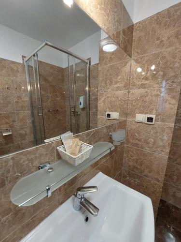 a bathroom with a sink and a mirror at Hotel u Liska in Kutno