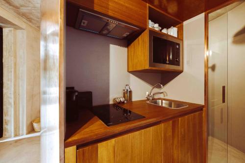 a small kitchen with a sink and a counter at Oliveiras Village — Agroturismo in Amarante