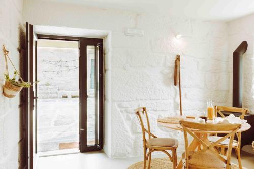 a dining room with a table and chairs at Oliveiras Village — Agroturismo in Amarante