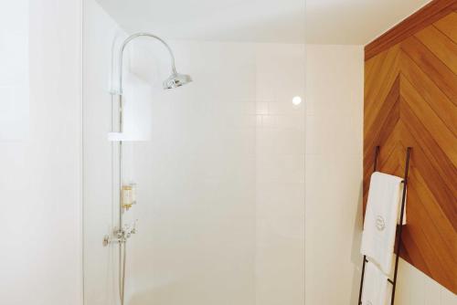 a shower with a glass door in a bathroom at Oliveiras Village — Agroturismo in Amarante