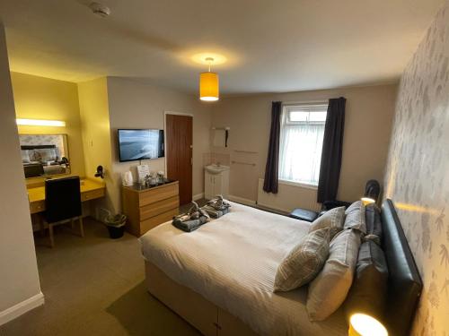 a bedroom with a bed and a desk and a television at YO10 in York