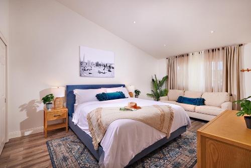 a bedroom with a bed with a dog laying on it at Fantastic Ocean View Remodeled All New Furnishings Pet Friendly AC in Oceanside