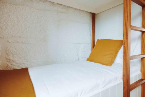 a bedroom with a bunk bed with a yellow pillow at Oliveiras Village — Agroturismo in Amarante