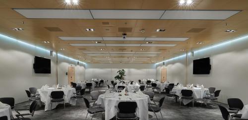 a banquet hall with white tables and chairs at Radisson Blu Hotel, Lucerne in Luzern