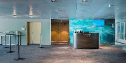 a lobby with a counter and a tv in a room at Radisson Blu Hotel, Lucerne in Luzern