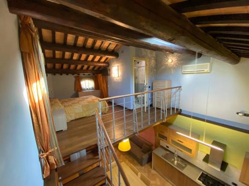 a room with a staircase leading up to a bedroom at Agriturismo Il Casale in Morrovalle