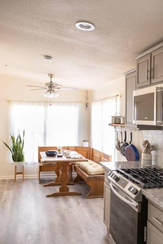 a kitchen with a table and a stove top oven at Hemingway House - Hot Tub Under The Desert Stars in Yucca Valley