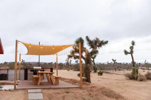 a gazebo with a picnic table in the desert at Hemingway House - Hot Tub Under The Desert Stars in Yucca Valley