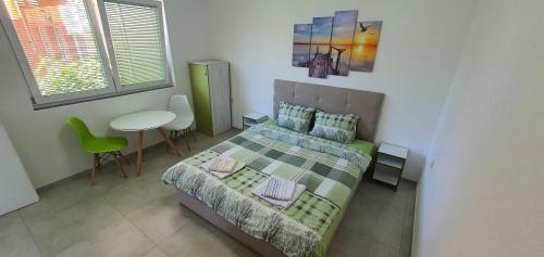a bedroom with a bed and a table and a chair at Antonio Apartments in Ohrid