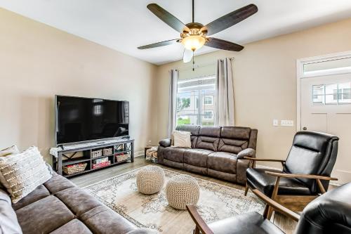 a living room with couches and a flat screen tv at Flat Rock Flat in Port Wentworth