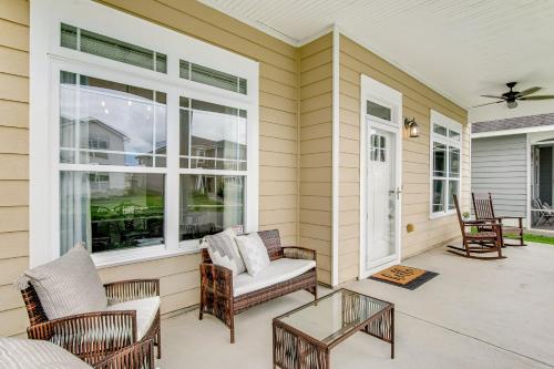 a screened in porch with chairs and a table at Flat Rock Flat in Port Wentworth