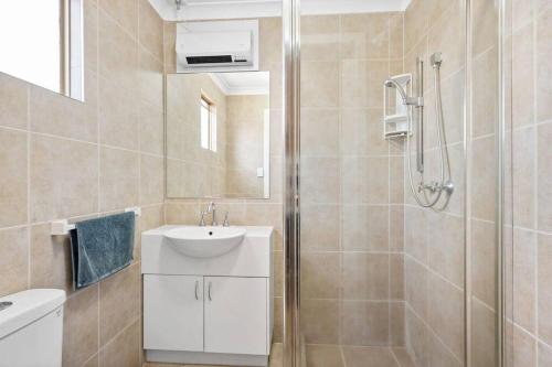 a bathroom with a white sink and a shower at 4-Bedroome home, new bathrooms and close to town in Kalgoorlie