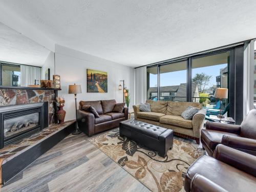 a living room with a couch and a fireplace at Sand & Sea: Beach Dreams (112) in Seaside