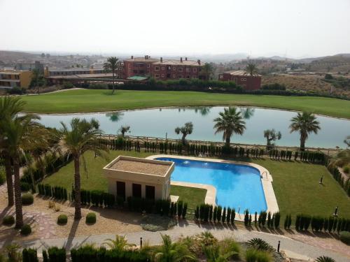 a view of a swimming pool at a resort at Apartamento unifamiliar Golf Vera urb privada y tranquila in Vera