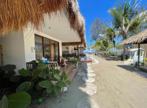 a building on the beach with a resort at Sunset Villas Palauig Zambales in Palauig