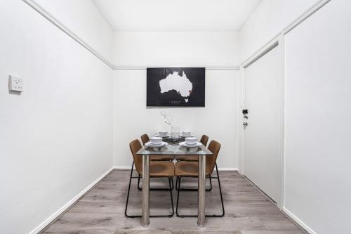 a dining room with a table and chairs at Burwood new 2 bedroom 2 bathroom apartment in Sydney