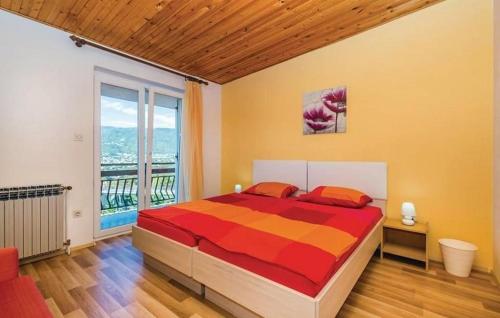 a bedroom with a bed and a large window at Apartments with a parking space Kastav, Opatija - 15287 in Kastav