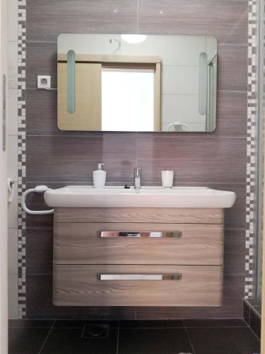 a bathroom with a sink and a mirror at Apartments by the sea Rukavac, Vis - 15369 in Vis