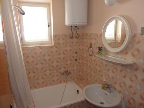 a bathroom with a sink and a mirror at Apartments and rooms with parking space Hvar - 15378 in Hvar
