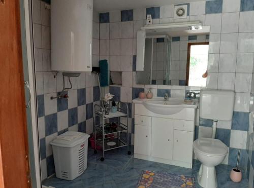 a small bathroom with a sink and a toilet at Apartments with parking space Cizici, Krk - 15415 in Malinska