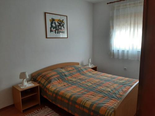 a bedroom with a bed and a picture on the wall at Apartments with parking space Cizici - Krk - 15415 in Malinska