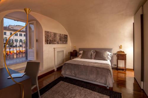 un dormitorio con una cama y una ventana en Palazzo De Cupis - Suites and View, en Roma