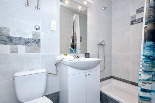 a bathroom with a sink and a toilet and a tub at Apartments with WiFi Stari Grad, Hvar - 15464 in Stari Grad
