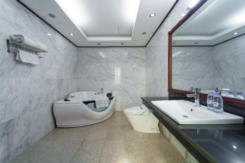 y baño con lavabo, aseo y espejo. en Khách sạn INCO 515.9 en Phủ Lý