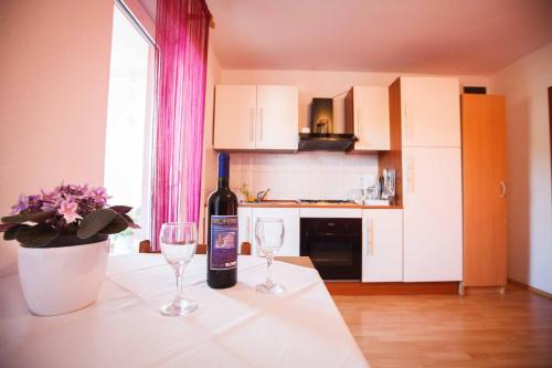 a bottle of wine sitting on a table with two glasses at Apartments with WiFi Hvar - 15506 in Hvar