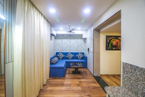 a hallway with a blue bench with pillows at Hotel Cama in Chandīgarh