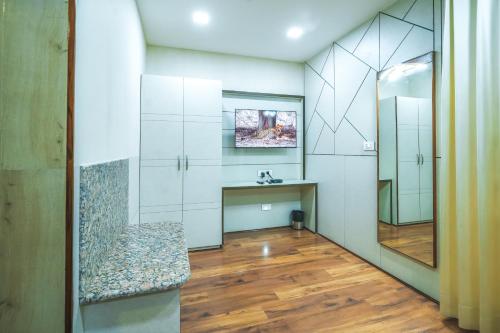 a bathroom with a sink and a mirror at Hotel Cama in Chandīgarh