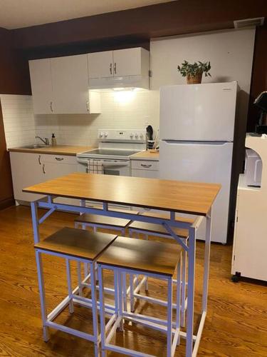 a kitchen with a table and a refrigerator at Farmhouse Resort in Midhurst