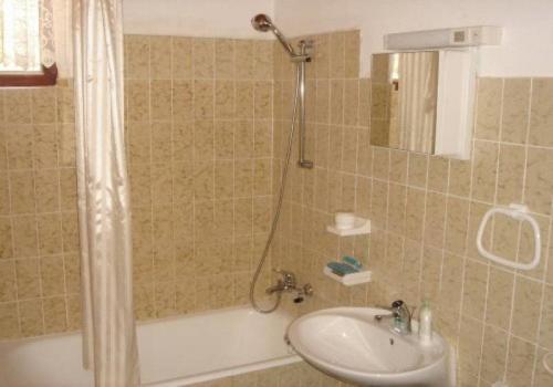 a bathroom with a shower and a sink and a tub at Apartments by the sea Kaprije - 15567 in Kaprije