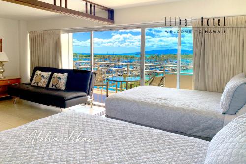 a hotel room with two beds and a balcony at New Aloha Ilikai 1free Parking in Honolulu